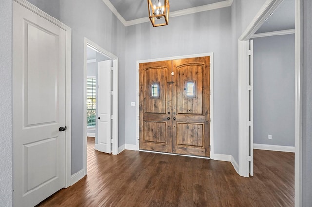 entrance foyer featuring an inviting chandelier, crown molding, and dark hardwood / wood-style floors