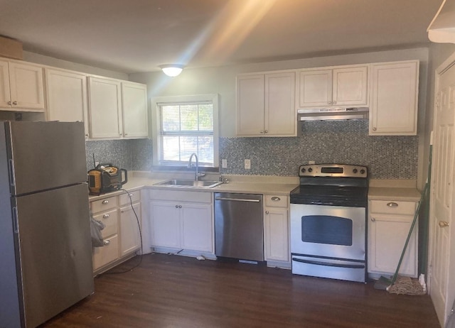 kitchen featuring appliances with stainless steel finishes, dark hardwood / wood-style flooring, white cabinets, backsplash, and sink