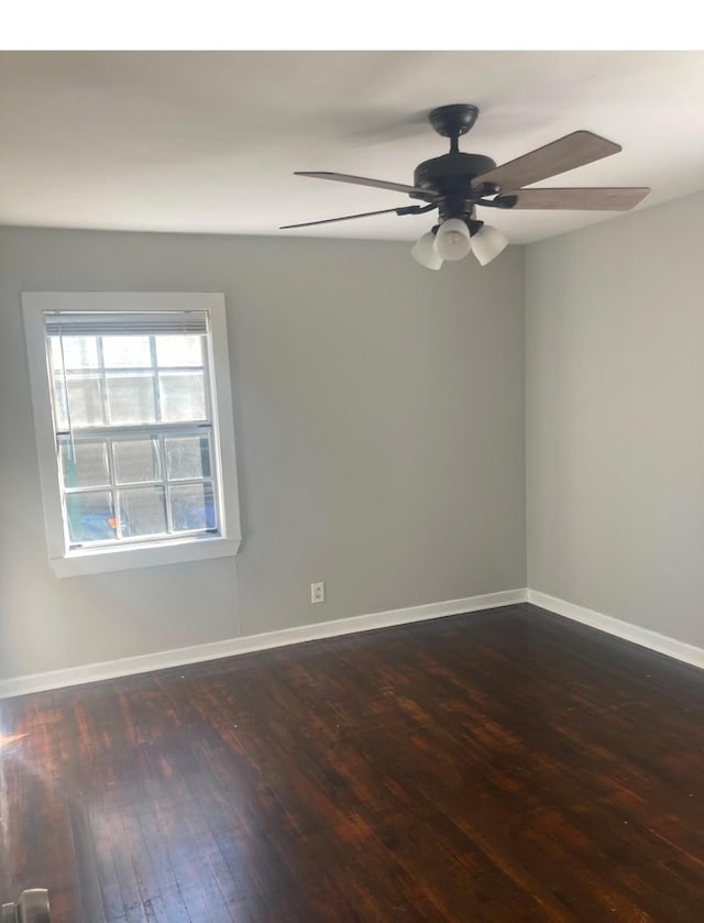 spare room featuring ceiling fan and dark hardwood / wood-style flooring