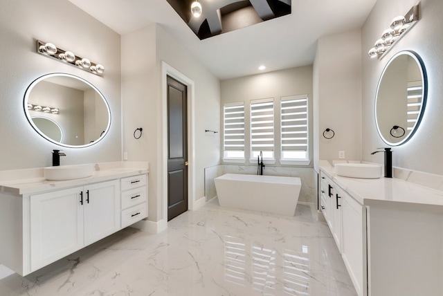 bathroom featuring a washtub and vanity