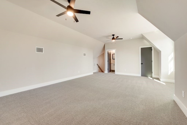 additional living space featuring vaulted ceiling, light colored carpet, and ceiling fan