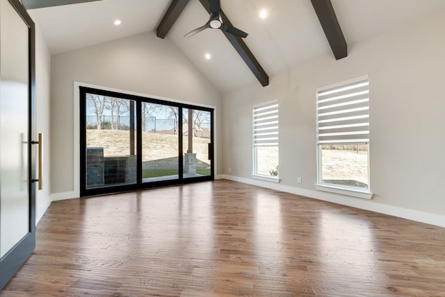 spare room featuring wood-type flooring, ceiling fan, and a wealth of natural light