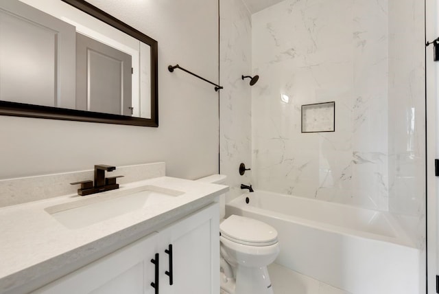 full bathroom featuring toilet, tiled shower / bath, and vanity