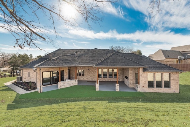 back of house with a patio, central AC unit, and a lawn