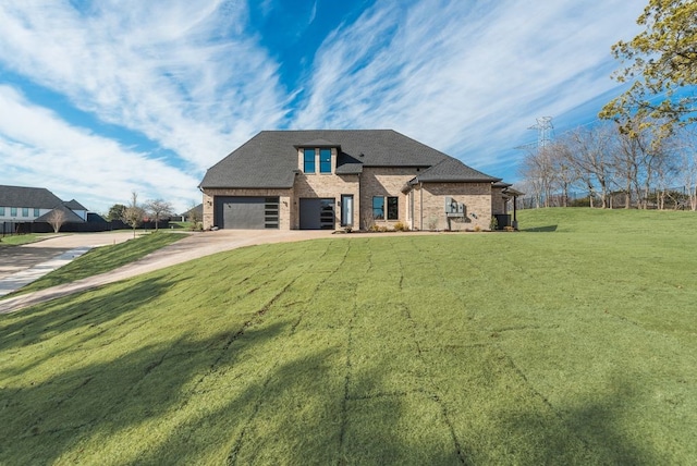 view of front of house featuring a front lawn and a garage