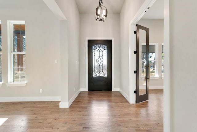 foyer featuring an inviting chandelier and light hardwood / wood-style flooring