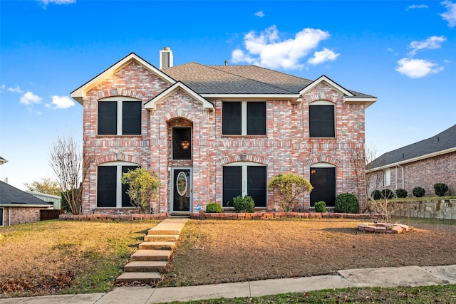 front facade with a front yard