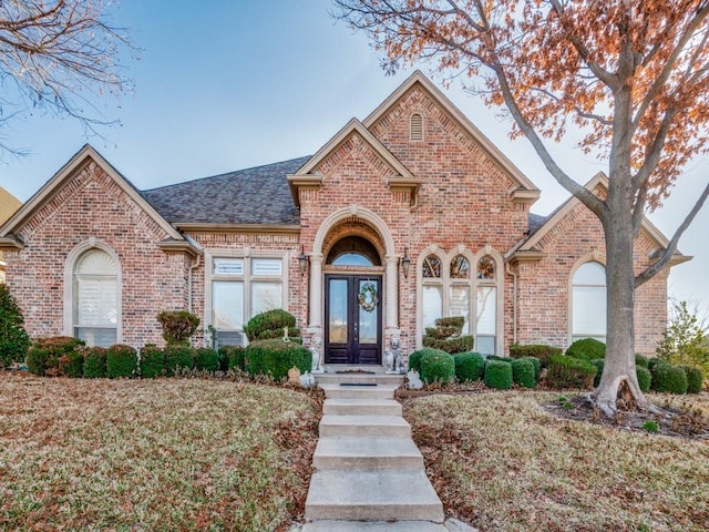 view of front of home featuring french doors and a front lawn