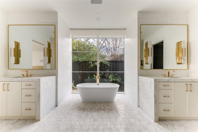 bathroom featuring a tub to relax in and vanity