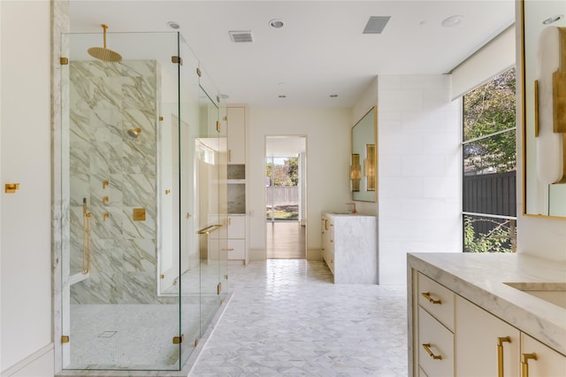 bathroom with an enclosed shower and vanity