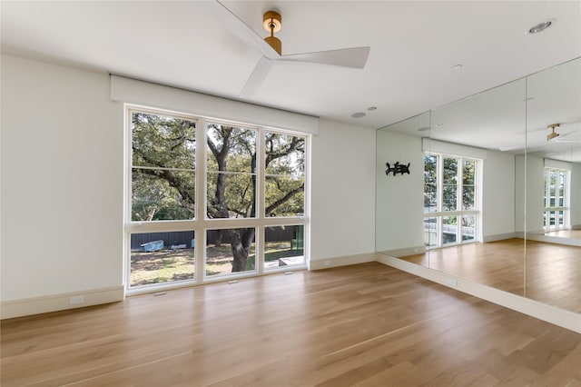 interior space with ceiling fan, light wood-type flooring, and plenty of natural light