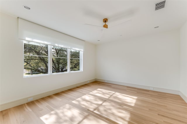 empty room featuring light wood-type flooring and ceiling fan