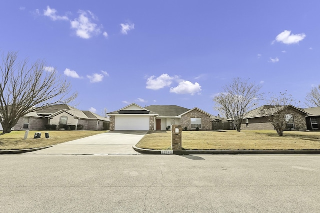 single story home with a front yard and a garage