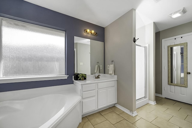 bathroom featuring a bath, vanity, tile patterned flooring, and plenty of natural light