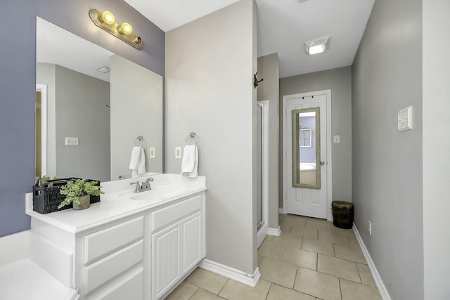 bathroom with tile patterned flooring, vanity, and a shower with shower door