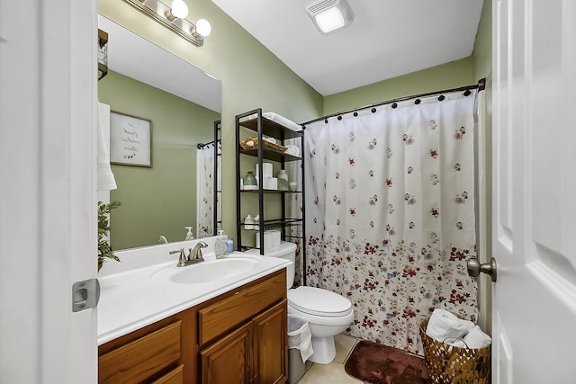 bathroom featuring toilet, vanity, tile patterned floors, and a shower with curtain