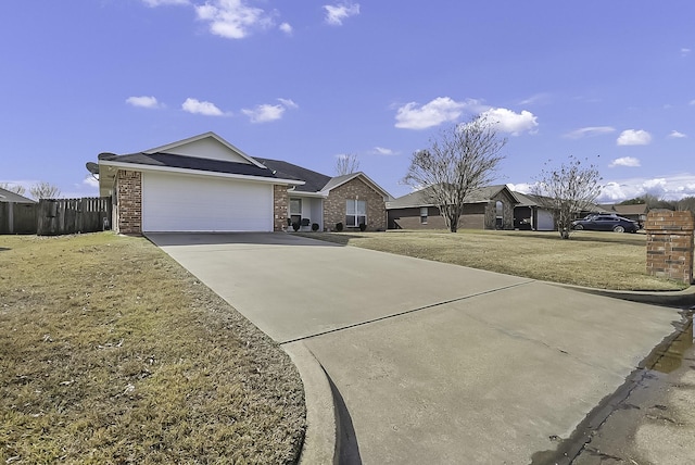 ranch-style house featuring a front lawn and a garage