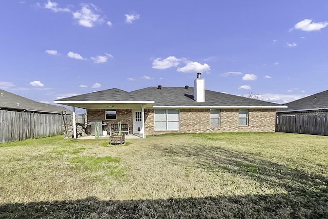 back of house featuring a yard