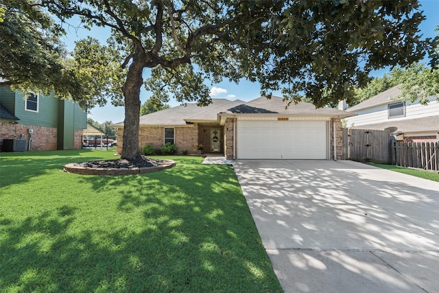 view of front facade featuring central AC, a front lawn, and a garage