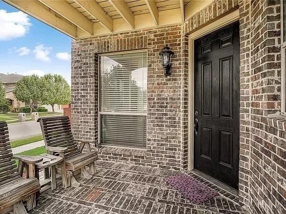 view of exterior entry with a porch