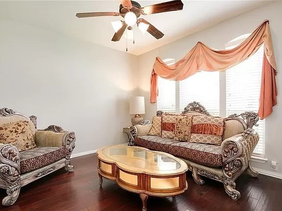 living room featuring ceiling fan and hardwood / wood-style floors