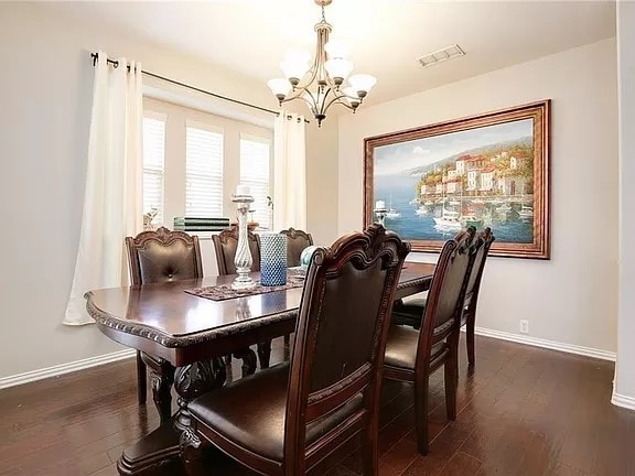 dining room with a chandelier and dark hardwood / wood-style floors