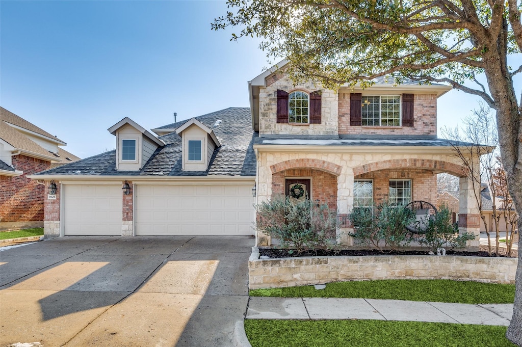 view of front of home featuring a porch and a garage