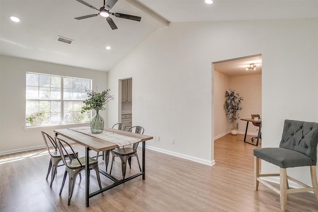 dining area with ceiling fan, light hardwood / wood-style flooring, and vaulted ceiling with beams