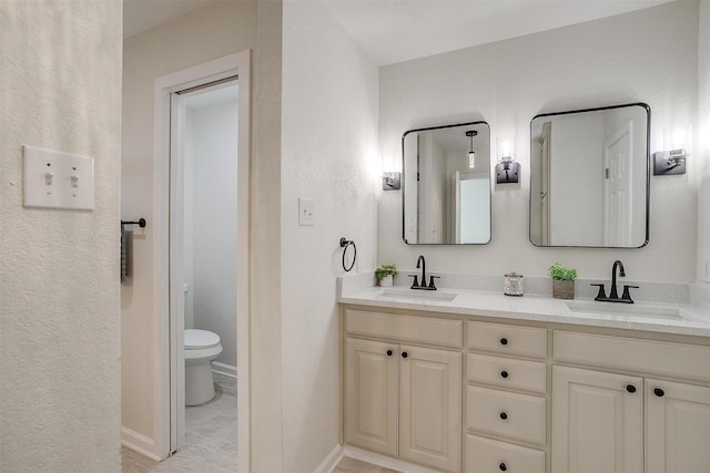 bathroom featuring toilet and vanity