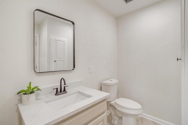 bathroom with hardwood / wood-style floors, vanity, and toilet