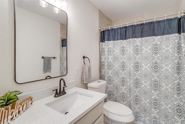 bathroom featuring toilet, a shower with curtain, and vanity