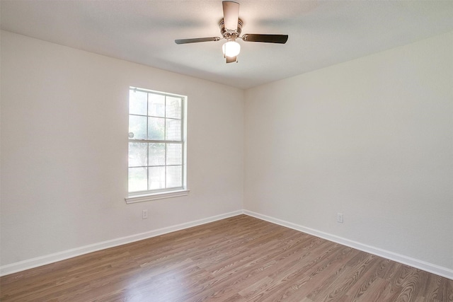 spare room with ceiling fan and wood-type flooring