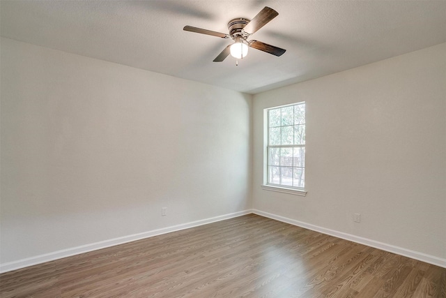 spare room featuring hardwood / wood-style floors and ceiling fan