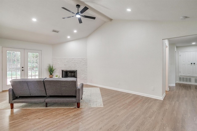 living room with light wood-type flooring, lofted ceiling with beams, ceiling fan, french doors, and a fireplace