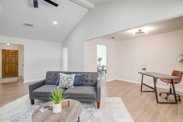 living room with high vaulted ceiling, light wood-type flooring, beam ceiling, and ceiling fan