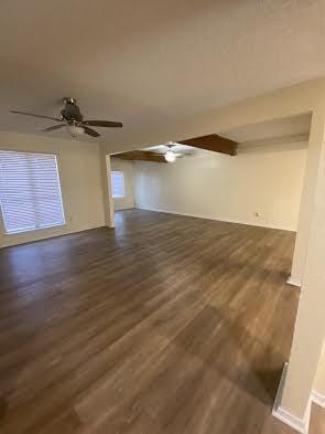 unfurnished living room featuring dark hardwood / wood-style floors