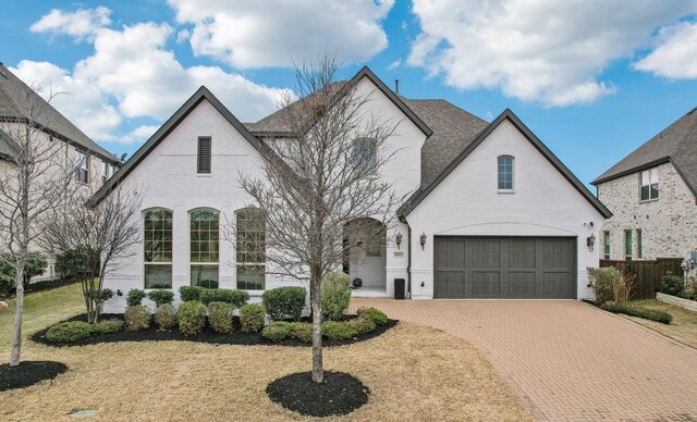 view of front of home with a front yard and a garage