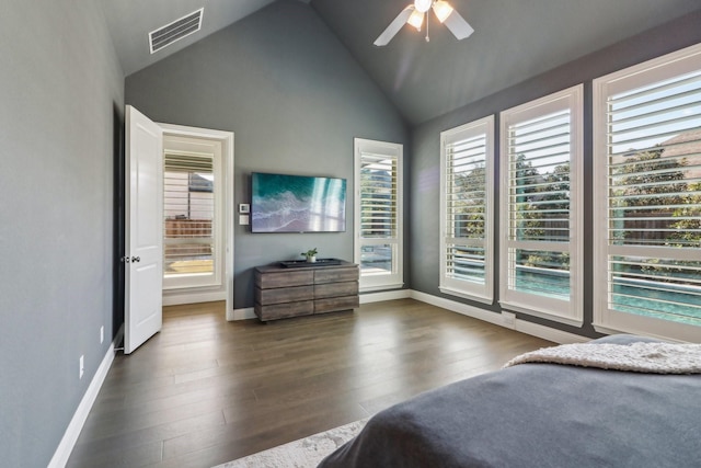 bedroom with lofted ceiling, wood finished floors, visible vents, and baseboards