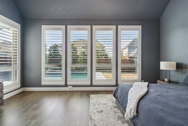 bedroom featuring baseboards and wood finished floors