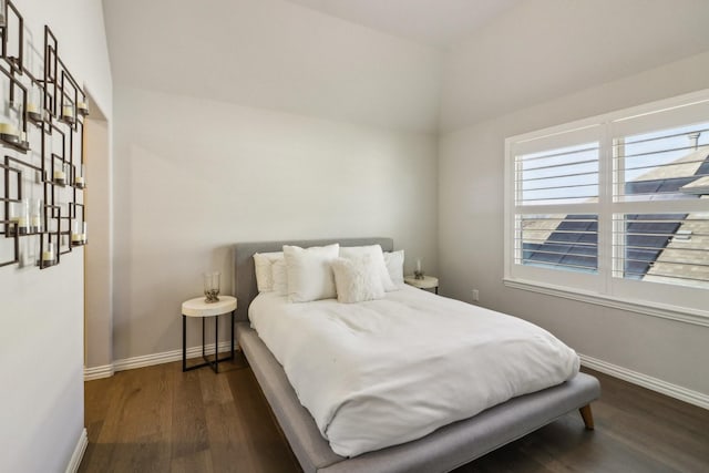 bedroom featuring dark wood-type flooring and baseboards