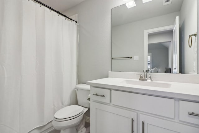 bathroom featuring toilet, a shower with curtain, and vanity