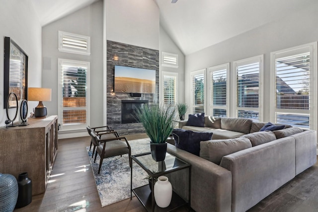 living room featuring high vaulted ceiling, dark wood-style flooring, and a fireplace