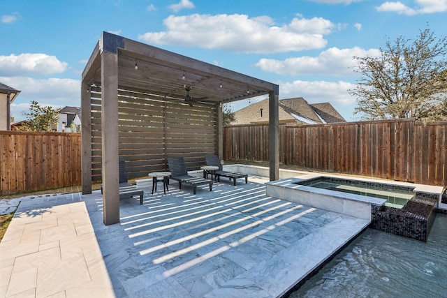 view of patio / terrace featuring an in ground hot tub, a fenced backyard, and a ceiling fan