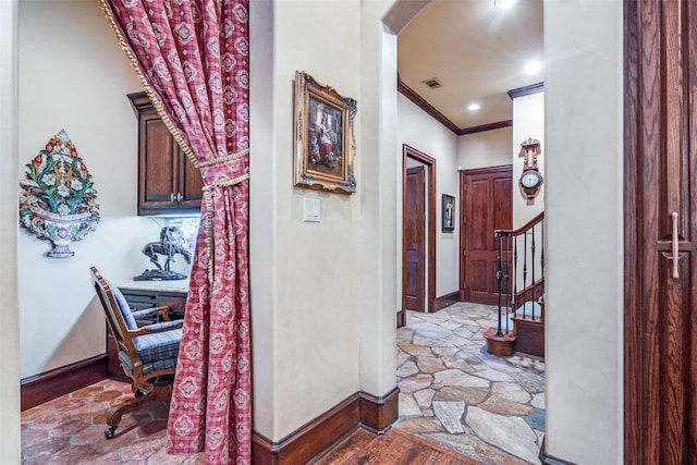 hallway with wood-type flooring and ornamental molding