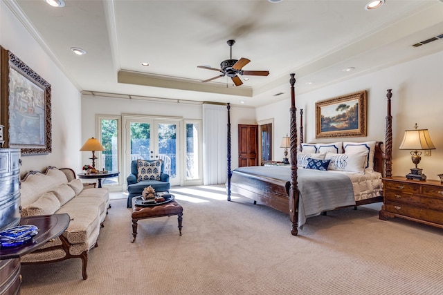 bedroom with french doors, ceiling fan, a tray ceiling, and crown molding