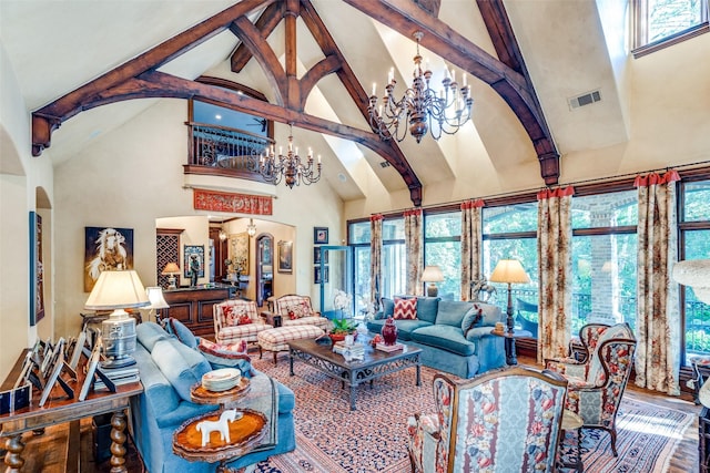 living room with high vaulted ceiling, hardwood / wood-style floors, and a chandelier