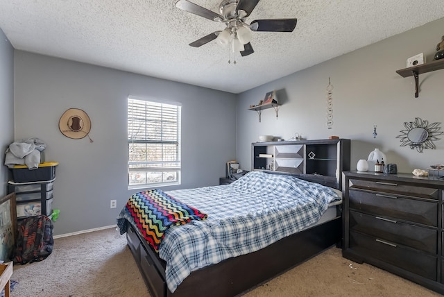 carpeted bedroom with a textured ceiling and ceiling fan