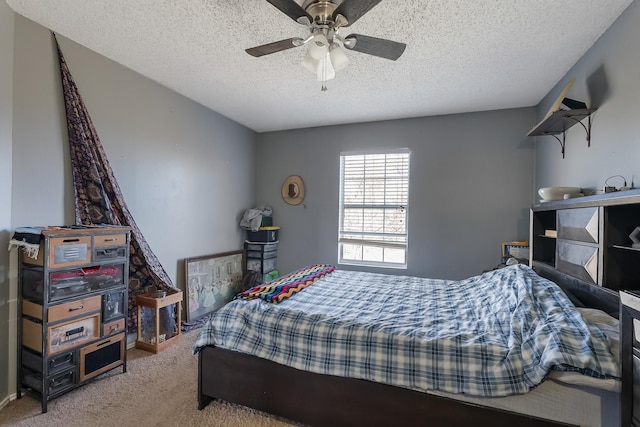 carpeted bedroom with a textured ceiling and ceiling fan