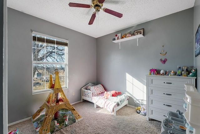 bedroom featuring a textured ceiling, ceiling fan, and carpet flooring