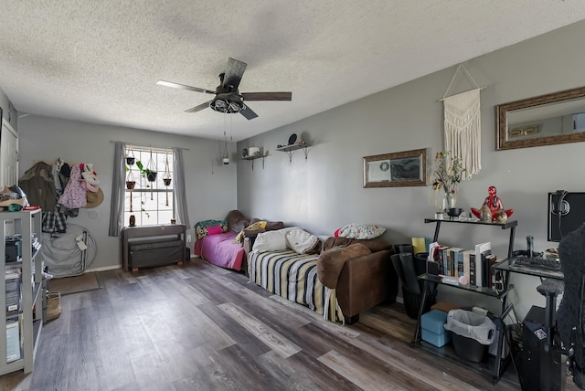 bedroom featuring ceiling fan, dark hardwood / wood-style floors, and a textured ceiling